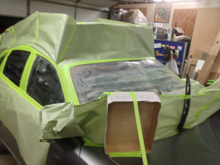 car covered with paper for acid rain removal